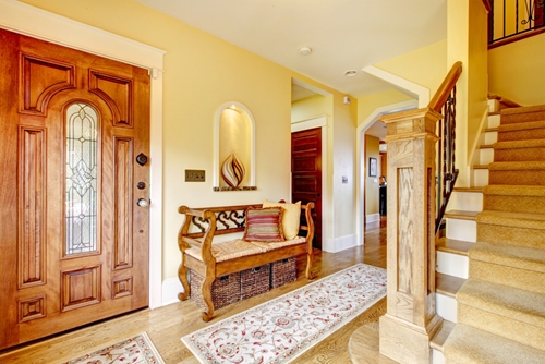 interior of home showing front door, rug and nearby stairs