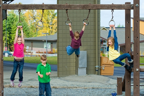 unsupervised children playing on playground equipment