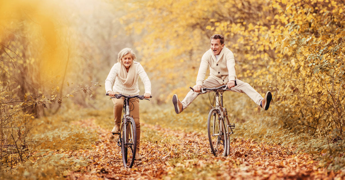 Image of a happy couple riding bikes without joint pain