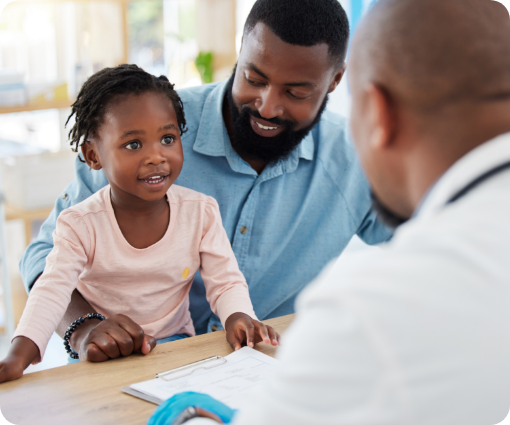 Man with daughter talking to doctor